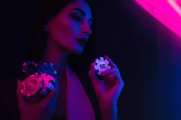 A glowing roulette wheel with cascading chips, symbolizing the engaging live and instant-win games available on BK33B.